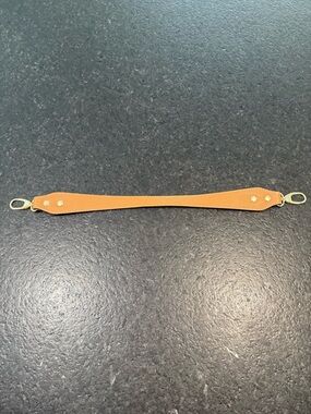 Tan Leather Handle Strap with Gold Hardware.